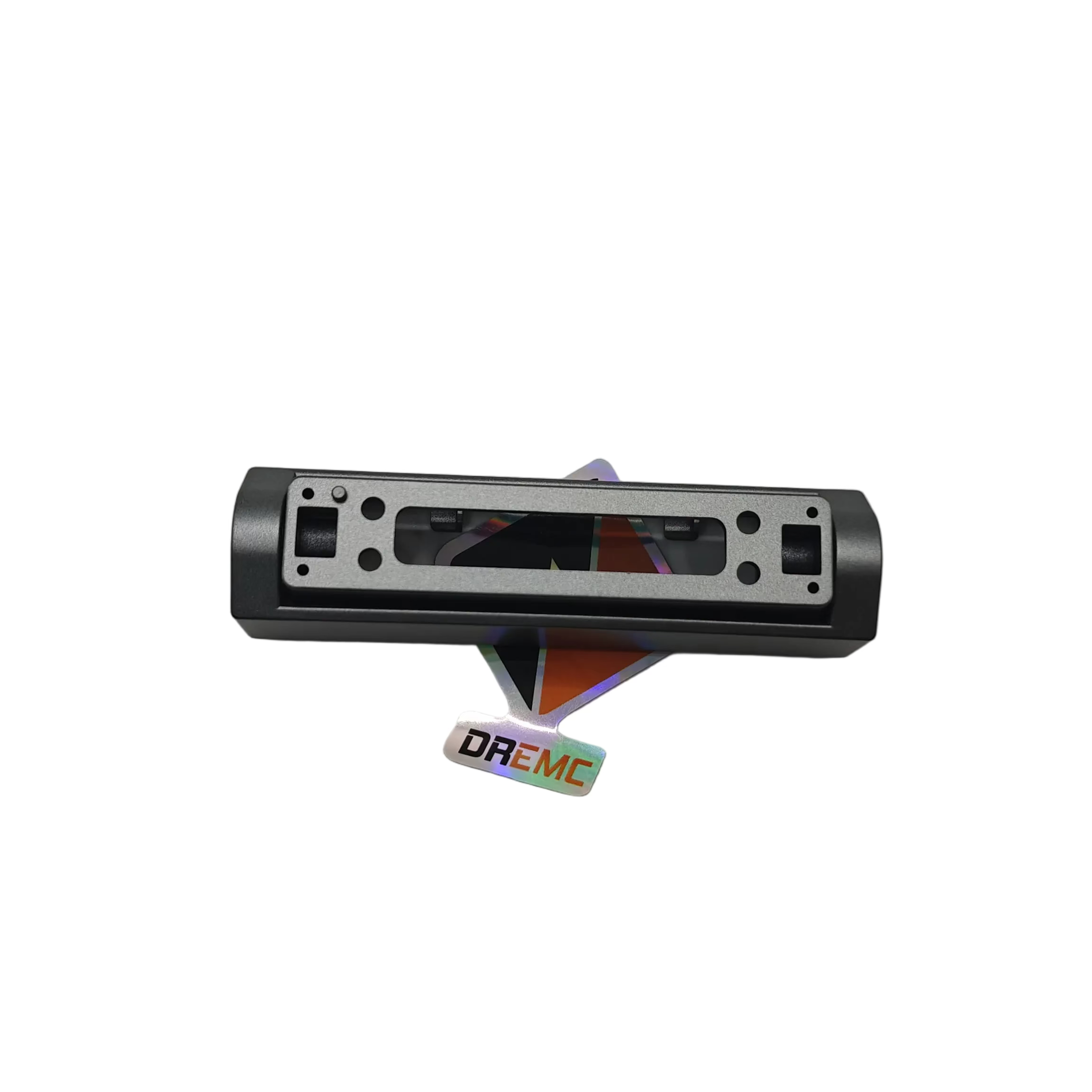 A silver and black metal electronic sensor or switch module with mounting holes, shown on a light gray background with a small DREMC brand sticker below it.
