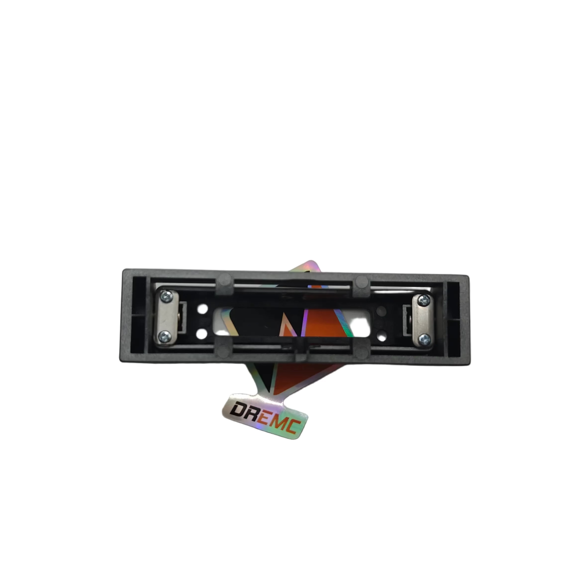 A small black rectangular electronic component with colorful internal elements and a small 'DREM' sticker below it, photographed on a plain light gray surface.