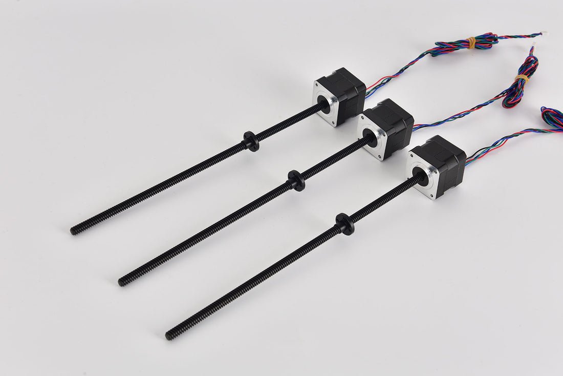 Three stepper motors with integrated lead screws for a 3D printer, displayed on a white background.