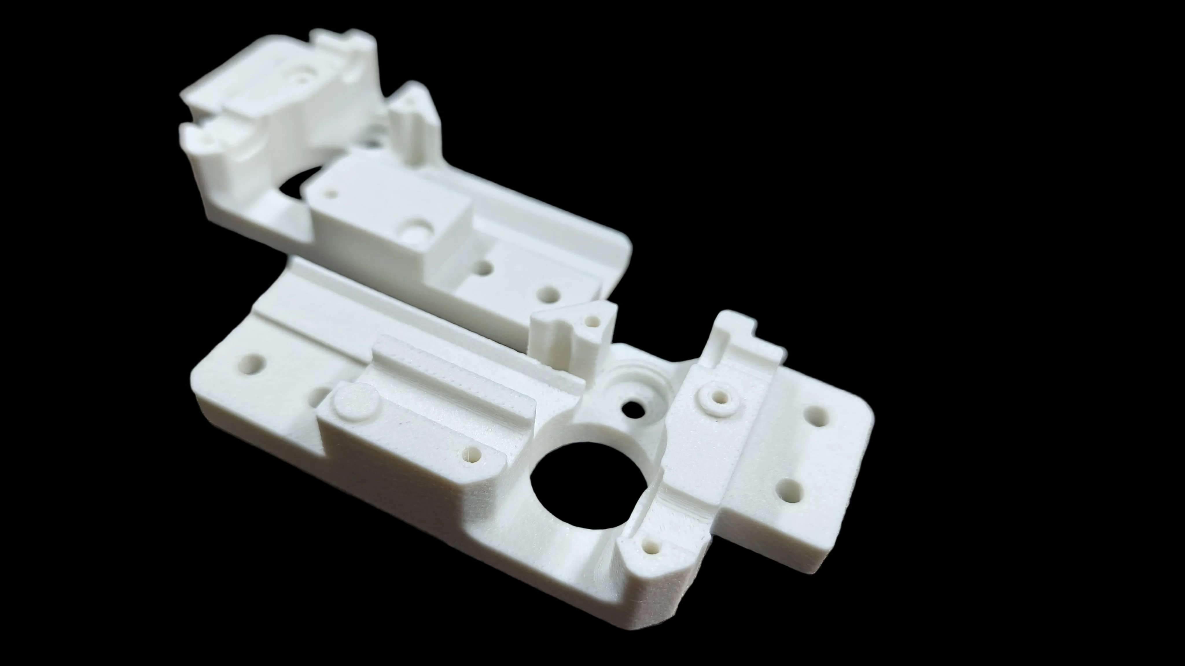 White/Natural DREMC PC PBT GF3D printed object on a textured surface