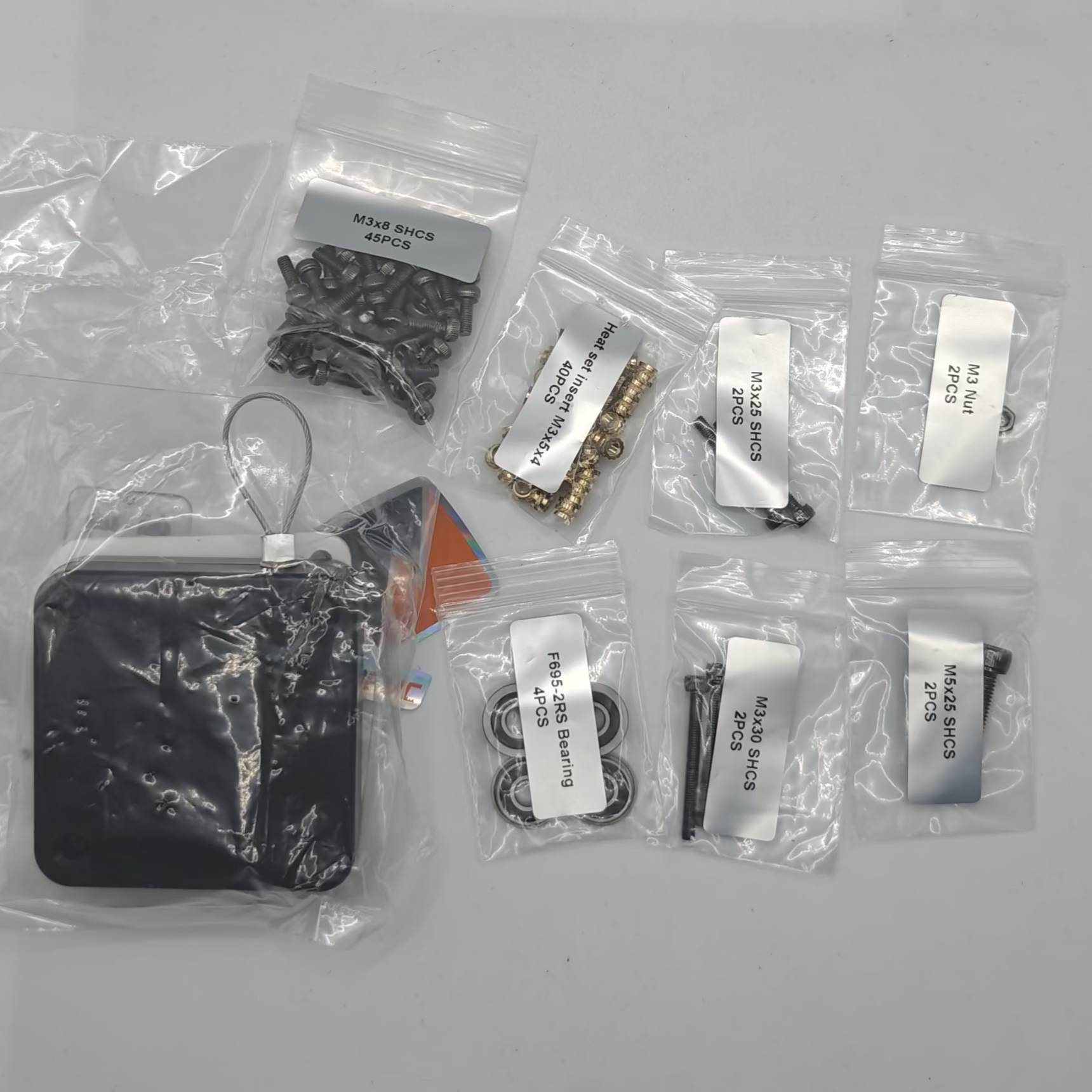 Set of electronic components in clear plastic bags on a white background