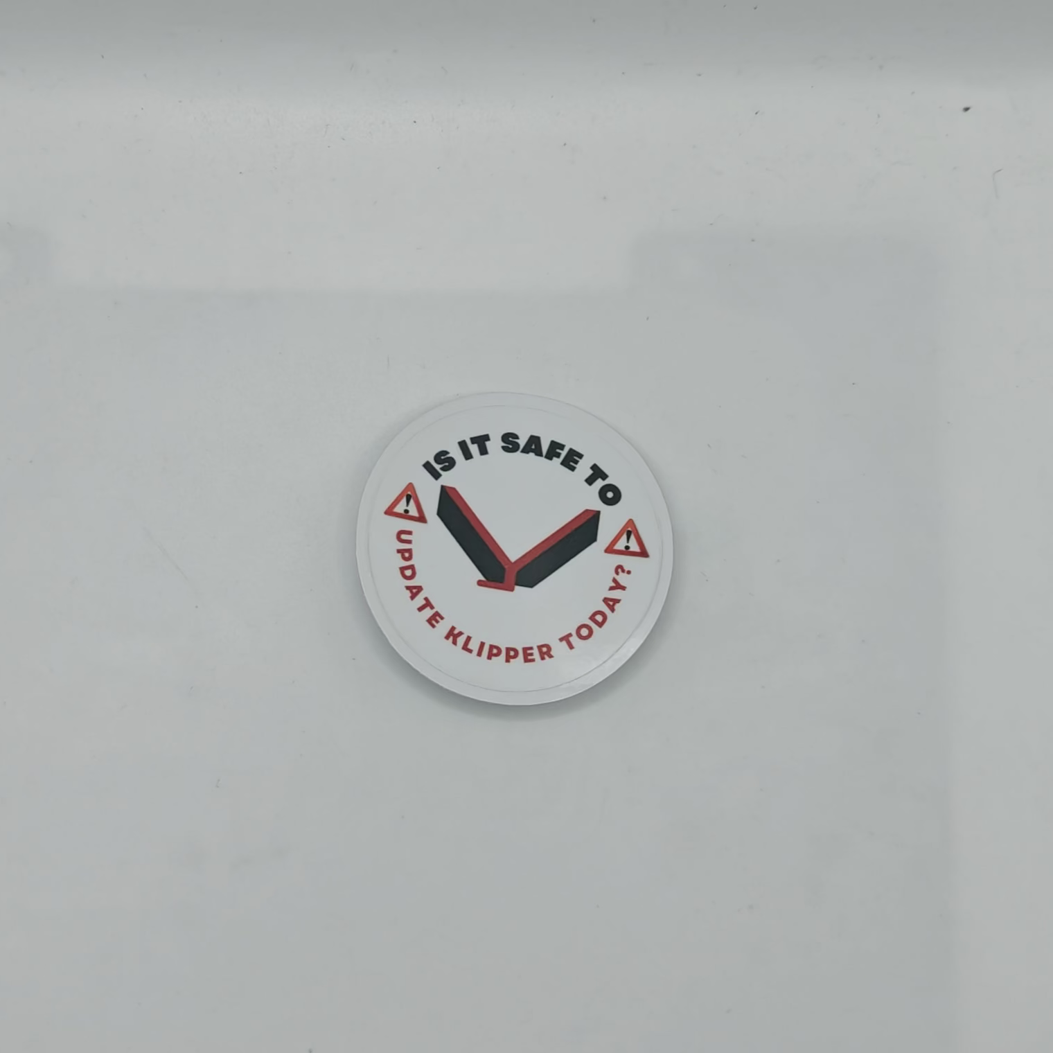 Circular sticker with text and clock design on a white background