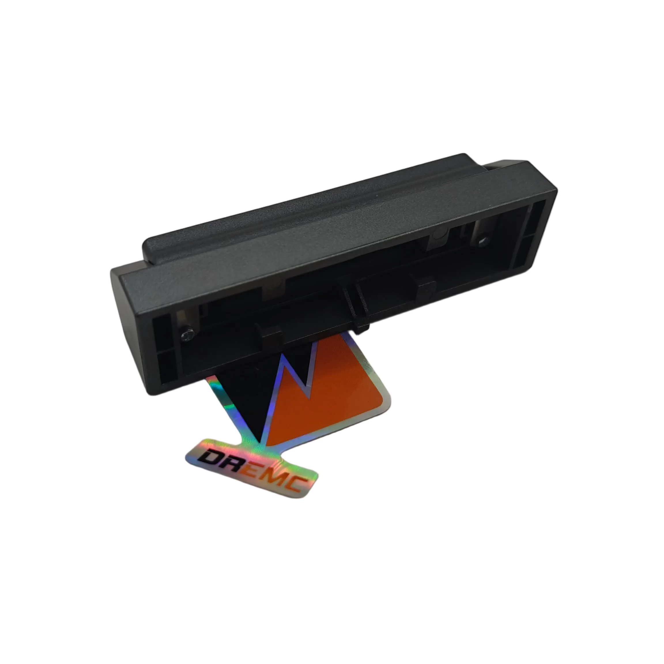 A black plastic rectangular component with a small colorful logo sticker that reads 'DREAMIC' in front of it, photographed on a plain light gray surface.