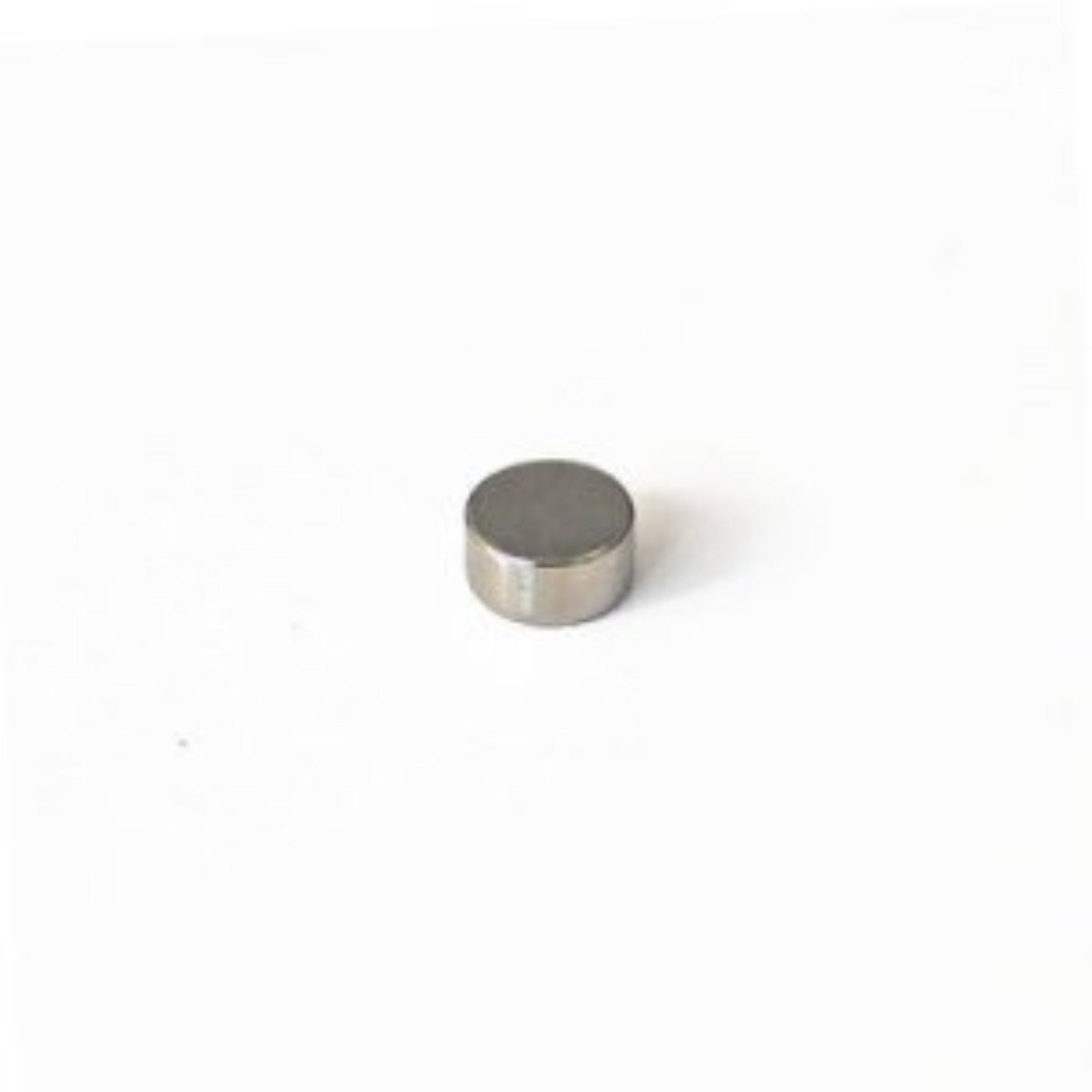A cylindrical Neodymium magnet with a nickel coating, 6mm in diameter and 3mm thick, placed on a plain background.