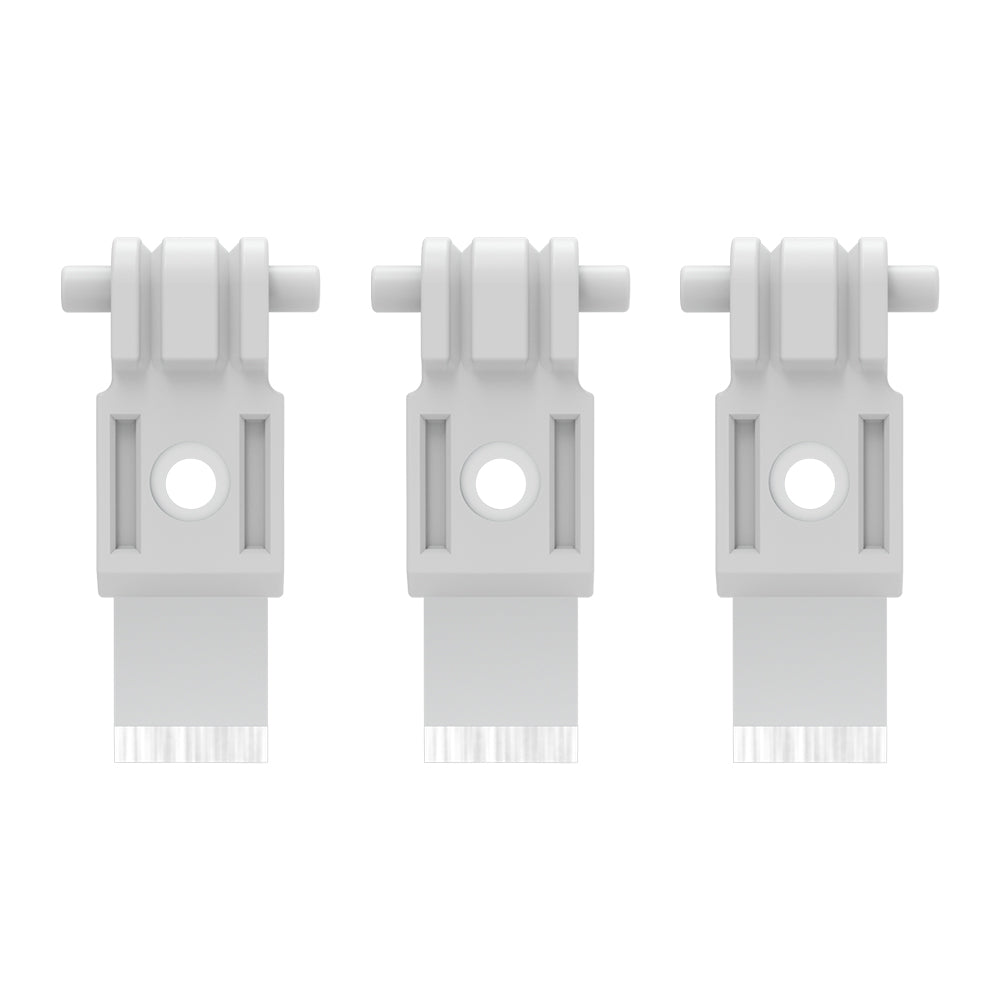 Three white plastic clips with bristles on a white background