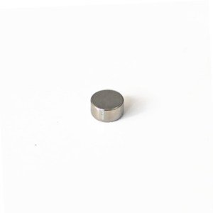A cylindrical neodymium magnet with a nickel coating on a white background